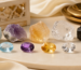 Raw crystals and polished gemstones placed side by side